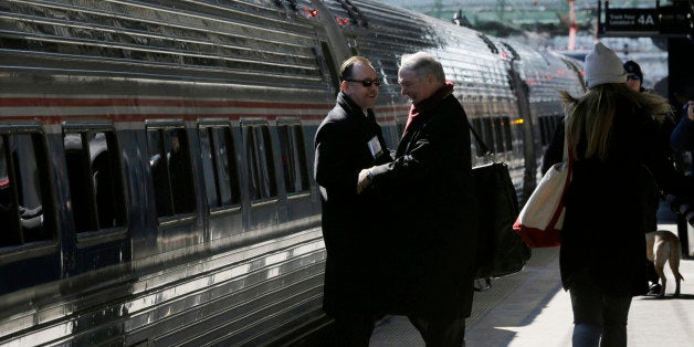 People greet one annother as they prepare to board an Amtrak train bound for Washington, D.C., as the state Chamber of Commer