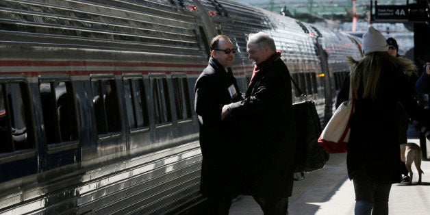 People greet one annother as they prepare to board an Amtrak train bound for Washington, D.C., as the state Chamber of Commerce commences its annual "Walk to Washington," Thursday, Feb. 19, 2015, in Trenton, N.J. Billed as the state's "premiere networking event," Thursday's "walk" gets its name because many of the nearly 600 attendees spend most of their time walking along train cars, shaking hands and meeting peers. The chamber chartered 14 cars and members pay nearly $600 to attend while non-members dole out nearly $700 for the event. (AP Photo/Mel Evans)