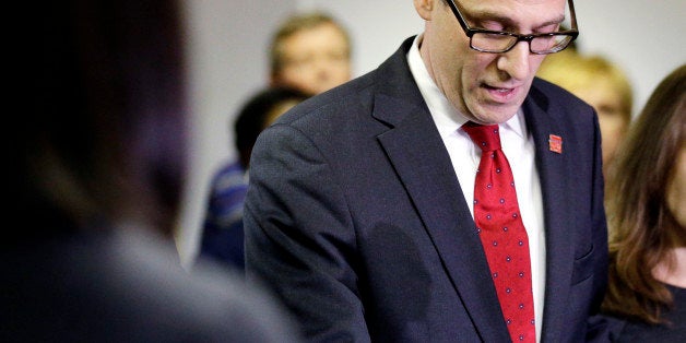 Chicago Teachers Union Vice President Jesse Sharkey looks down as he answers a question at a news conference in Chicago on Thursday, Oct. 9, 2014. Sharkey said the union's president, Karen Lewis, has "a serious illness" and he is assuming her duties. He said she's "alert and comfortable" after a successful surgery. (AP Photo/Nam Y. Huh)