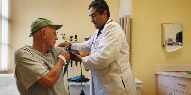MIAMI - JANUARY 18: Dr. Olveen Carrasquillo, Chief of General Internal Medicine University of Miami, conducts a checkup on J