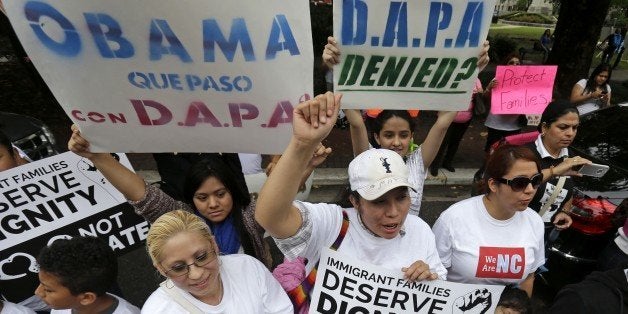 Demonstrators, led by the New Orleans Worker Center for Racial Justice and the Congress of Day Laborers, participate in a rally outside the U.S. Fifth Circuit Court of Appeals in New Orleans, Friday, April 17, 2015. A three-judge panel began hearing arguments whether to lift a temporary hold imposed by a federal judge in Texas on President Barack Obama's executive action seeking to shield millions of immigrants from deportation. (AP Photo/Gerald Herbert)