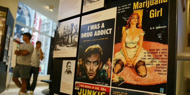 NEW YORK - SEPTEMBER 15: Sensationalized vintage entertainment posters depict drug users at Target America: Drug Traffickers, Terrorists and You, a Drug Enforcement Administration (DEA) traveling museum exhibit September 15, 2004 in Times Square, New York City. The exhibit uses graphic photos and drug paraphernalia to illustrate the societal costs of the production and trafficking of illegal drugs. It also aims to make a link between drug use and global terrorism. (Photo by Spencer Platt/Getty Images)