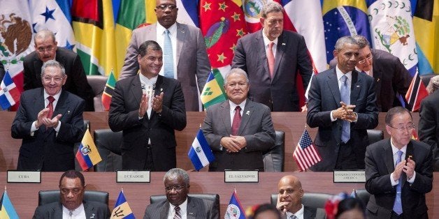 President Barack Obama, right middle row, and Cuba's President Raul Castro, left middle row, applaud with other leaders during the inauguration ceremony of the Summit of the Americas in Panama City, Friday, April 10, 2015. Obama is looking to the Summit of the Americas to chart a less conflictive future with Latin America, a region that has long chafed at Washington's dominance. (AP Photo/Pablo Martinez Monsivais)