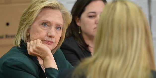 Democratic presidential hopeful and former US Secretary of State, Hillary Clinton(C) participates in a small business roundtable discussion with members of the small business community at Capital City Fruit on April 15, 2015 in Norwalk, Iowa. Clinton has spent the last two days in Iowa to focus on smaller communities in Iowa and have discussions about how to make the economy work for everyday Americans. AFP PHOTO / MICHAEL B. THOMAS (Photo credit should read Michael B. Thomas/AFP/Getty Images)