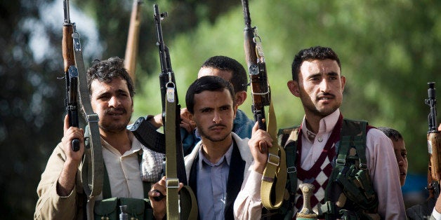 In this Thursday, April 16, 2015 photo, Shiite rebels, known as Houthis, hold up their weapons as they attend a demonstration against an arms embargo imposed by the U.N. Security Council on Houthi leaders, in Sanaa, Yemen. (AP Photo/Hani Mohammed)