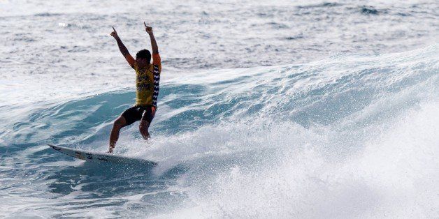 Brazil's Gabriel Medina celebrates after a exiting from a barrel in the finals during the final day of the Billabong Pipeline Masters event of the Vans Triple Crown of Surfing at Ehukai Beach Park on December 19, 2014 in Haleiwa, Hawaii. AFP PHOTO / KENT NISHIMURA (Photo credit should read Kent Nishimura/AFP/Getty Images)