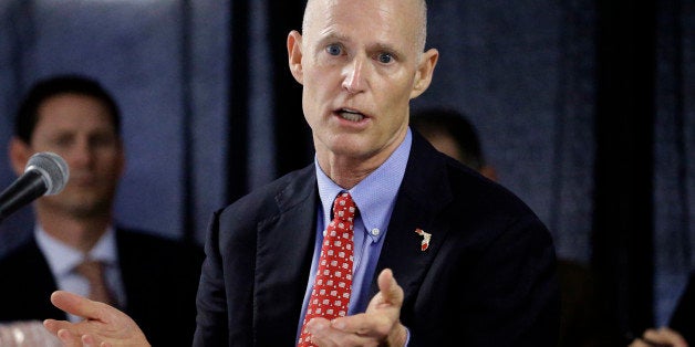 FILE - In this Feb. 5, 2015 file photo, Florida Gov. Rick Scott gestures during a cabinet meeting at the Florida State Fair, in Tampa, Fla. Scott, who has repeatedly tangled with public record advocates, media organizations and others over whether he has followed the stateâs transparency law, has insisted did not use private email accounts for state business. (AP Photo/Chris O'Meara, file)