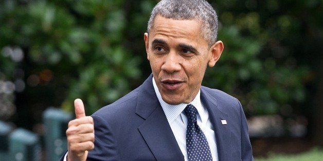 US President Barack Obama gives the thumbs up as he walks out of the White House in Washington on October 7, 2012 before depa