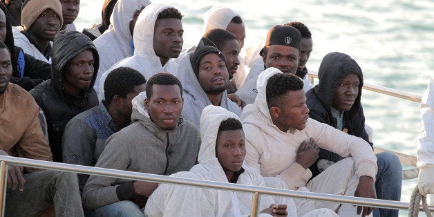 Migrants arrive at the Sicilian Porto Empedocle harbor, Italy, Monday, April 13, 2015. Italy's Coast Guard helped save 144 migrants Monday from a capsized boat in the waters off Libya and spotted nine bodies. It was the most dramatic of numerous rescue operations that brought thousands to safety in recent days, as good weather has encouraged the desperate to set out on smugglers' vessels. The overturned boat was spotted 80 miles north of Libya, Coast Guard Cmdr. Filippo Marini told The Associated Press in a telephone interview. (AP Photo/Calogero Montanalampo)