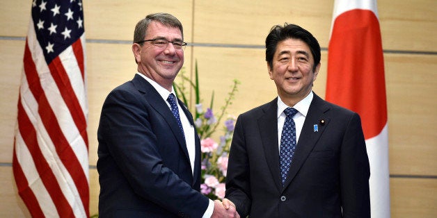 U.S. Defense Secretary Ash Carter, left, shakes hands with Japan's Prime Minister Shinzo Abe at the start of their meeting at Abe's official residence in Tokyo, Wednesday, April 8, 2015. The first revision of the U.S.-Japan Defense Guidelines in 17 years will "transform" the bilateral alliance, U.S. Defense Secretary Carter said Wednesday. (AP Photo/Franck Robichon, Pool)