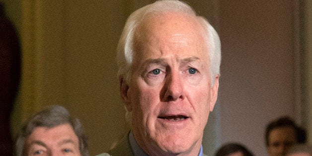 FILE - In this March 17, 2015 file photo, Senate Majority Whip John Cornyn of Texas speaks to reporters on Capitol in Washing