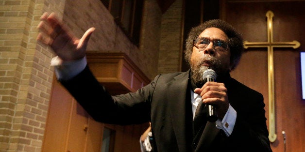 Cornel West talks to protesters before a march to the Ferguson, Mo., police station, Monday, Oct. 13, 2014, in Ferguson. Activists planned a day of civil disobedience to protest the shooting of Michael Brown in August and a second police shooting in St. Louis last week. (AP Photo/Charles Rex Arbogast)