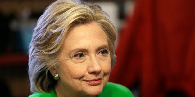 IN this April 14, 2015, photo, Democratic presidential candidate Hillary Rodham Clinton meets with local residents at the Jon