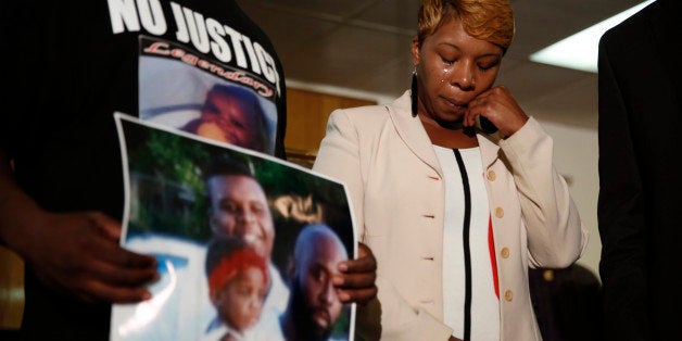 FILE - In this Aug. 11, 2014 file photo, Lesley McSpadden, the mother of 18-year-old Michael Brown, wipes away tears as Brown