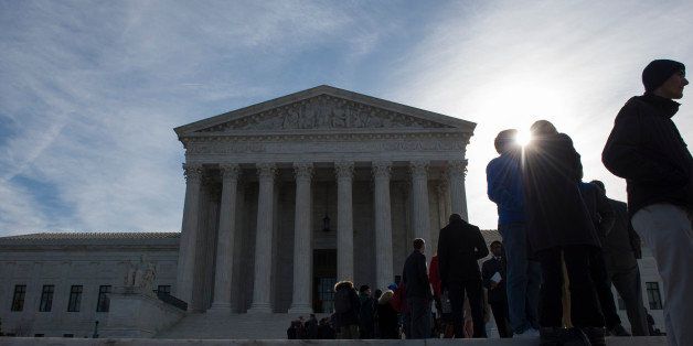 People wait in line outside the Supreme Court in Washington, Monday, March 23, 2015, in hopes to gain admittance for oral arguments. (AP Photo/Molly Riley)