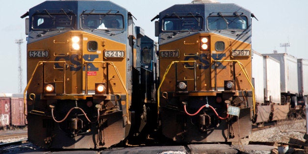 FILE - In this file photograph taken Oct. 7, 2010, a CSX train rolls along the tracks passing another CSX train in Buffalo, N.Y. Higher rates are helping freight railroad CSX Corp. boost profits by 14 percent despite lower coal shipments. CSX said Tuesday, April 17, 2012 that it earned $449 million, or 43 cents per share, in the first quarter, up from $395 million, or 35 cents per share, a year ago. (AP Photo/David Duprey, file)