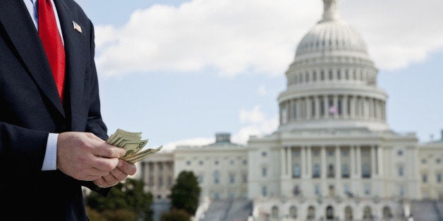 A politician counting money in front of the US Capitol Building