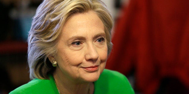 IN this April 14, 2015, photo, Democratic presidential candidate Hillary Rodham Clinton meets with local residents at the Jon