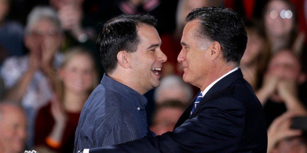 Republican presidential candidate, former Massachusetts Gov. Mitt Romney embraces Wisconsin Gov. Scott Walker who introduced him at a campaign event at Wisconsin Products Pavilion at State Fair Park, Friday, Nov. 2, 2012, in West Allis, Wis. (AP Photo/David Goldman)