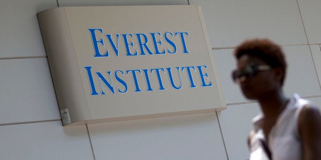 FILE - In this July 8, 2014 file photo, a woman walks past the Everest Institute in Silver Spring, Md. Corinthian Colleges, which owns Everest, Heald College and WyoTech schools, is being sued by the federal Consumer Financial Protection Bureau for what it calls a âpredatory lending scheme,â the agency said Tuesday, Sept. 16, 2014. (AP Photo/Jose Luis Magana, File)