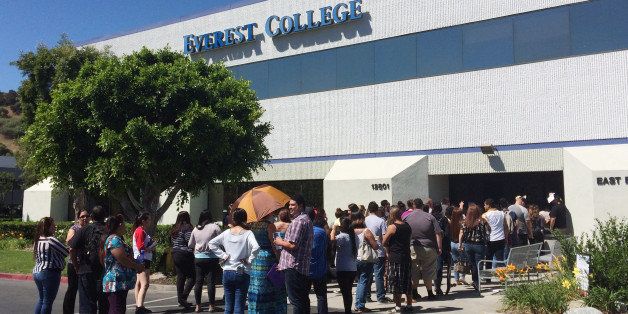 Students wait outside Everest College, Tuesday, April, 28, 2015 in Industry, Calif., hoping to get their transcriptions and information on loan forgiveness and transferring credits to other schools. Corinthian Colleges shut down all of its remaining 28 ground campuses on Monday, April 27, displacing 16,000 students. The shutdown comes less than two weeks after the U.S. Department of Education announcing it was fining the for-profit institution $30 million for misrepresentation. (AP Photo/Christine Armario)