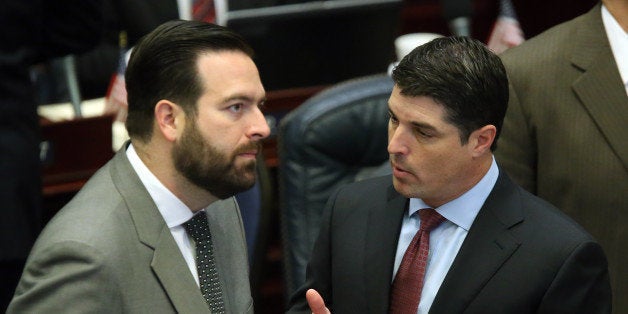 House speaker Steve Crisafulli, R-Merritt Island, left, confers with Rep. Jose Diaz, R-Miami-Dade county, during a legislative session, Tuesday, April 28, 2015, in Tallahassee, Fla. (AP Photo/Steve Cannon)