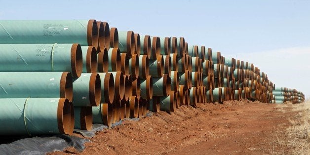 FILE - In this Feb. 1, 2012 file photo, miles of pipe for the stalled Canada-to-Texas Keystone XL pipeline are stacked in a field near Ripley, Okla. The recent surge in oil production, from roughly 5 million barrels a day in 2008 to 8.9 million barrels in 2014, has led to more than 11,600 miles of crude oil pipeline being added to the domestic oil network _ the equivalent of 14 Keystone XL pipelines. (AP Photo/Sue Ogrocki, File)