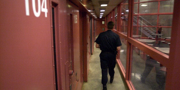 ** FILE ** A guard walks down past prisoner cells at the Connecticut Supermax facility called Northern Correctional Institution in Somers, Conn., Feb. 22, 2001. Five of eight Connecticut death row inmates are on a hunger strike Thursday, Feb. 3, 2005, asking to be allowed to interact with one another and calling their years of solitary confinement "inhumane and tantamount to psychological torture.'' (AP Photo/Steve Miller)