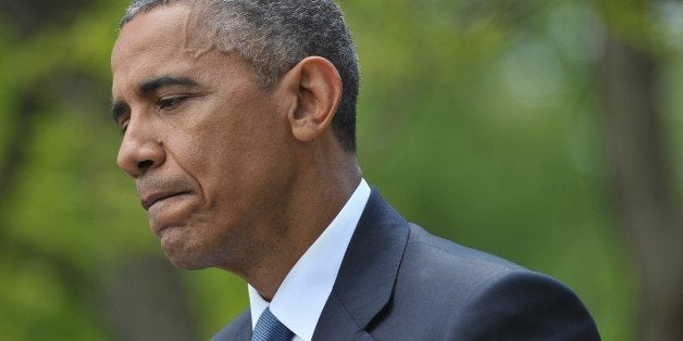 US President Barack Obama pauses while speaking during a joint press conference with Japan's Prime Minister Shinzo Abe in the