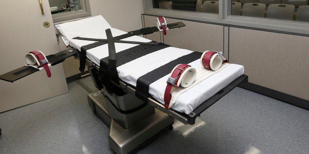 FILE - In this Thursday, Oct. 9, 2014 photo, the gurney in the the execution chamber at the Oklahoma State Penitentiary is pictured in McAlester, Okla. Oklahoma plans to resume executions Thursday, Jan. 15, 2015, after botching its last one and will use the same three-drug method as a Florida lethal injection scheduled for the same day. (AP Photo/Sue Ogrocki, File)