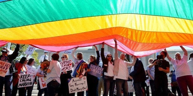 WASHINGTON, DC - APRIL 28: Protesters hold pro-gay rights flags outside the US Supreme Court on April 28, 2015 in Washington