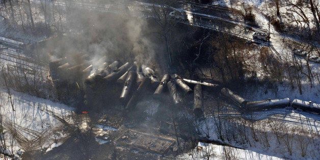 FILE-This aerial Feb. 17, 2015 file photo photo made available by the Office of the Governor of West Virginia shows a derailed train in Mount Carbon, WVa. As investigators in West Virginia and Ontario pick through the wreckage from the latest pair of oil train derailments to result in massive fires, U.S. transportation officials predict many more catastrophic wrecks involving flammable fuels in coming years absent new regulations. (AP Photo/ Office of the Governor of West Virginia, Steven Wayne Rotsch,File)