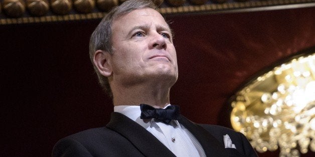 Chief Justice of the US Supreme Court John Roberts listens during the 37th Kennedy Center Honors at the Kennedy Center December 7, 2014 in Washington, DC. Artists from various mediums were honored for their contribution to arts in the United States. AFP PHOTO/Brendan SMIALOWSKI (Photo credit should read BRENDAN SMIALOWSKI/AFP/Getty Images)