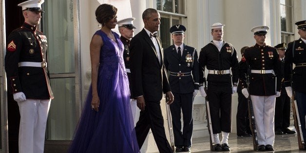 US First Lady Michelle Obama and US President Barack Obama arrive to greet Japan's Prime Minister to the White House for a state dinner April 28, 2015 in Washington, District of Columbia. The Obamas are hosting Japan's Prime Minister Shinzo Abe for a State Dinner during his trip to the United States. AFP PHOTO/BRENDAN SMIALOWSKI (Photo credit should read BRENDAN SMIALOWSKI/AFP/Getty Images)