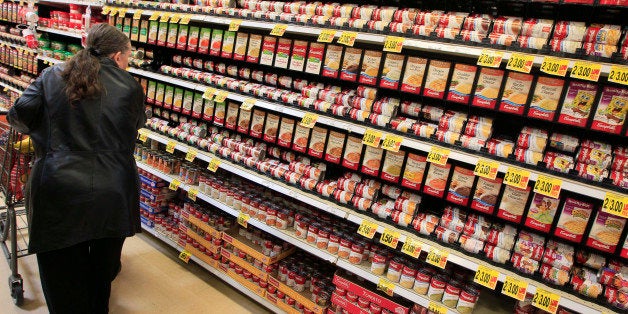 Mary Long walks down the canned soup aisle, Tuesday, Feb. 7, 2012, at a Kroger Co. grocery store in Cincinnati. (AP Photo/Al Behrman)