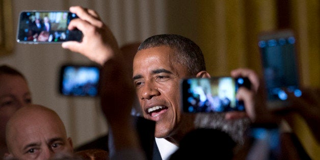 President Barack Obama greets people in the audience after speaking during a Cinco de Mayo reception in the East Room of the