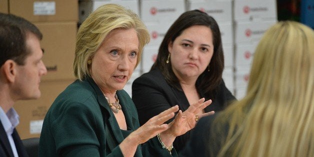 Democratic presidential hopeful and former US Secretary of State, Hillary Clinton(C) participates in a small business roundtable discussion with members of the small business community at Capital City Fruit on April 15, 2015 in Norwalk, Iowa. Clinton has spent the last two days in Iowa to focus on smaller communities in Iowa and have discussions about how to make the economy work for everyday Americans. AFP PHOTO / MICHAEL B. THOMAS (Photo credit should read Michael B. Thomas/AFP/Getty Images)