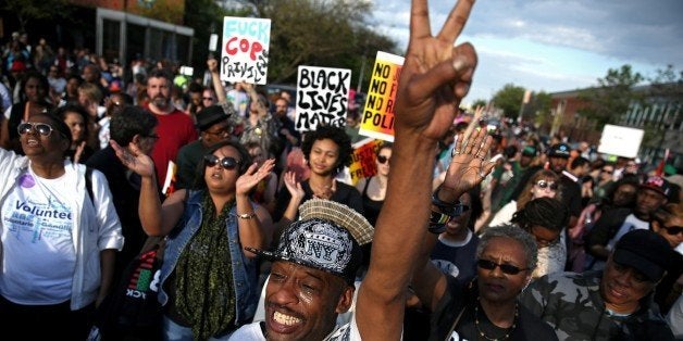 BALTIMORE, MD - MAY 02: Protesters march on the street at North Ave., and Pennsylvania Ave., in West Baltimore a day after Baltimore authorities released a report on the death of Freddie Gray, May 2, 2015 in Baltimore, Maryland. Marilyn Mosby, Baltimore City state's attorney, ruled the death of Freddie Gray a homicide and that criminal charges would be filed against six Baltimore City Police officers. Gray, 25, was arrested for possessing a switch blade knife on April 12 outside the Gilmor Homes housing project on Baltimore's west side. According to his attorney, Gray died a week later in the hospital from a severe spinal cord injury he received while in police custody. (Photo by Patrick Smith/Getty Images)