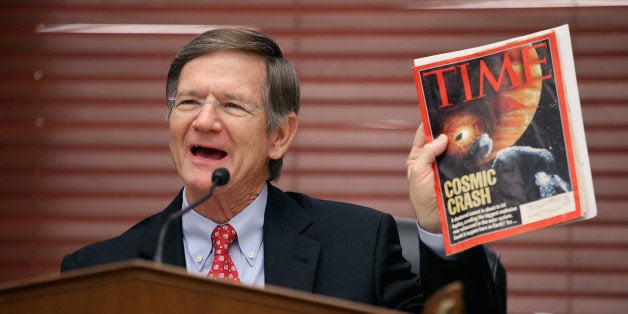 WASHINGTON, DC - MARCH 19: House Science, Space and Technology Committee Chairman Lamar Smith (R-TX) holds up a copy of TIME Magazine with a cover article about 'near-Earth objects' during a hearing in the Rayburn House Office Building on Capitol Hill March 19, 2013 in Washington, DC. The committee asked government and military experts about efforts to track and mitigate asteroids and meteors. (Photo by Chip Somodevilla/Getty Images)