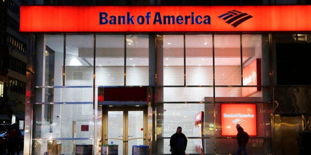 In this Jan. 14, 2015 photo, people walk past a branch of Bank of America, in New York. The Federal Reserve on Wednesday, March 11, 2015 announced it is ordering Bank of America to revise its plans for increasing dividends or buying back stock, saying there are gaps in its risk planning. (AP Photo/Mark Lennihan)