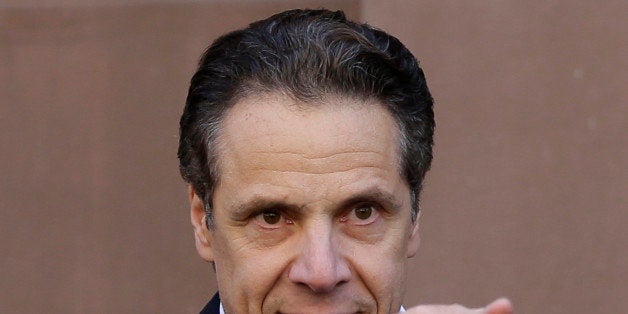 New York Gov. Andrew Cuomo points to supporters in New York, Wednesday, April 29, 2015. New York state will end its AIDS epidemic by 2020, Cuomo said, vowing to add the virus to the list of largely vanquished killers such as polio and smallpox. (AP Photo/Seth Wenig)