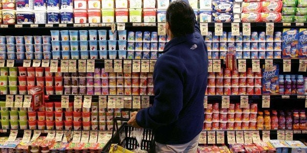 **FILE** A man shops in the yogurt aisle at a Safeway store in San Francisco in this July 18, 2006 file photo. Grocery store chain Safeway Inc. said Thursday its fourth-quarter profit climbed 78 percent on higher revenue and a tax gain. (AP Photo/Jeff Chiu, file)