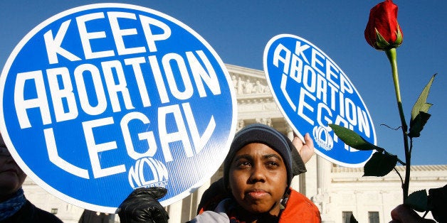 WASHINGTON - JANUARY 22: Local pro-choice activist Lisa King holds a sign in front of the U.S. Supreme Court as a pro-life a