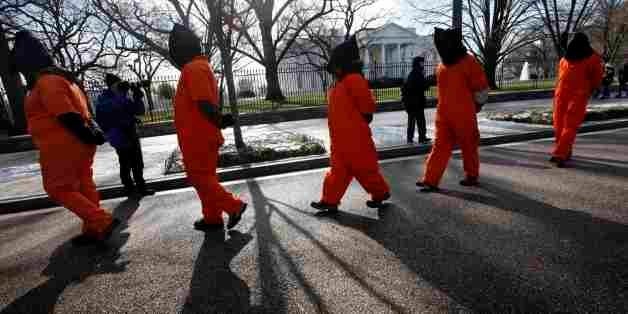 Human rights activists protest in front of the White House in Washington, on Monday Jan. 11, 2010. Dozens of human rights activists marked the eighth anniversary of the opening of the Guantanamo Bay prison for detainees by protesting near the White House. Members of Witness Against Torture are calling on President Barack Obama to follow through with his pledge to close the U.S. prison in Cuba. The group also opposes holding prisoners without charge or trial within the United States. (AP Photo/Jacquelyn Martin)