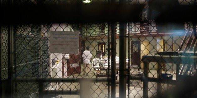 In this photo reviewed by a U.S. Department of Defense official, a prisoner walks through a communal pod inside an area of th
