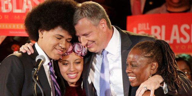 FILE - In this Sept. 10, 2013, file photo, New York Democratic mayoral hopeful Bill de Blasio embraces his son Dante, left, daughter Chiara, second from left, and wife Chirlane McCray, right, at his election headquarters after polls closed in the city's primary election in New York. One of the longest-serving members of Congress, U.S. Rep. Charles Rangel, D-NY, is in a fight just to hang on to his seat, but de Blasio, the race's potential kingmaker, who ran Rangel's 1994 campaign is remaining silent. (AP Photo/Kathy Willens, File)