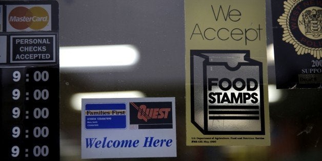 A supermarket displays stickers indicating they accept food stamps in West New York, N.J., Monday, Jan. 12, 2015. New Jersey lawmakers are considering a bill that would require the state to expedite the handling of applications for food stamps. (AP Photo/Seth Wenig)