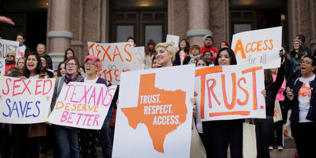 College students and abortion rights activists hold signs during a rally on the steps of the Texas Capitol, Thursday, Feb. 26, 2015, in Austin, Texas. The demonstrators are urging an easing of strict limits on abortion that prompted massive protests but were overwhelmingly approved last session. (AP Photo/Eric Gay)