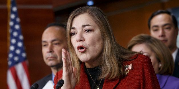 Rep. Loretta Sanchez, D-Calif., joined at left by Rep. Luis Gutierrez, D-Ill., and others, responds to questions during a Congressional Hispanic Caucus news conference on their efforts to implement President Barack Obama's immigration executive action to delay deportations of immigrant children, Friday, Feb. 13, 2015, on Capitol Hill in Washington. (AP Photo/J. Scott Applewhite)