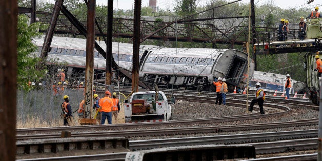 Emergency personnel gather near the scene of a deadly train wreck, Wednesday, May 13, 2015, after a fatal Amtrak derailment